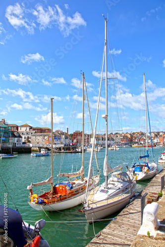 Sailing boats in the old town of Weymouth Harbour in Dorset, England, UK.