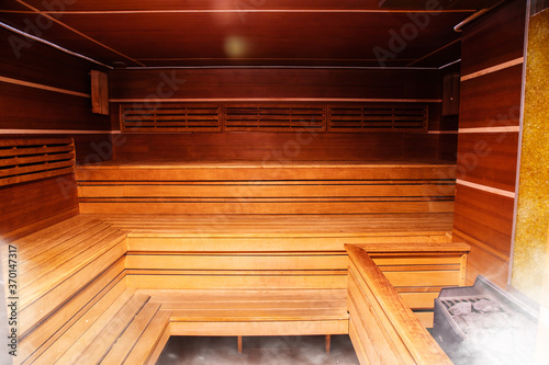 Interior of Finnish sauna or classic wooden sauna. Relax and treatment in the spa