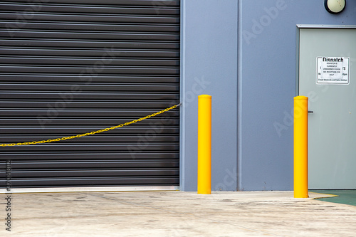 Warehouse dispatch with closed roller door and yellow safety chain