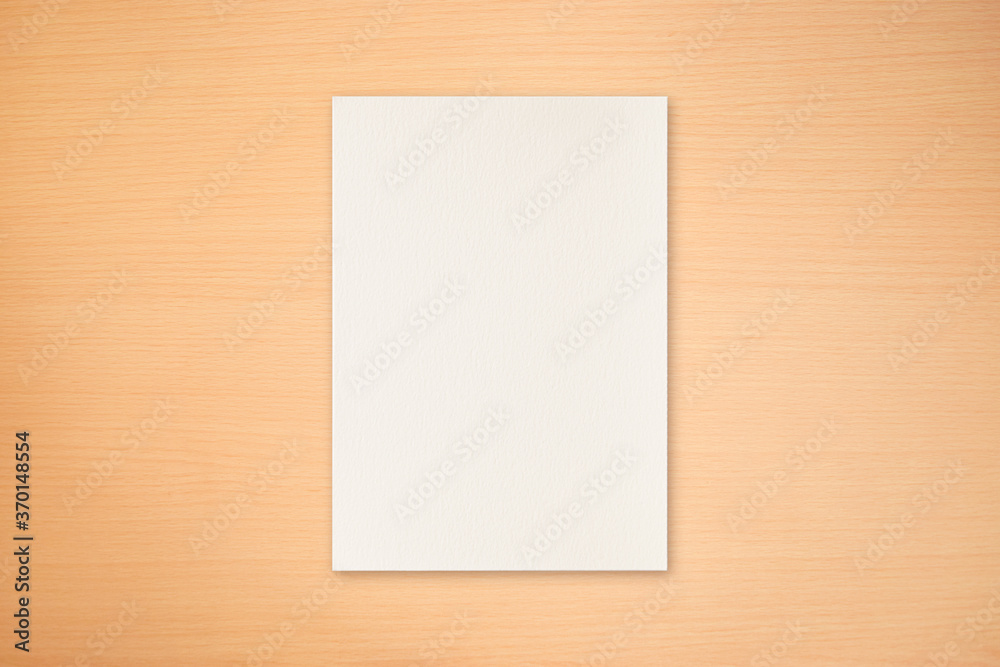 Light wood texture with blank paper to use in design work Light wood texture with blank paper to use in design work
