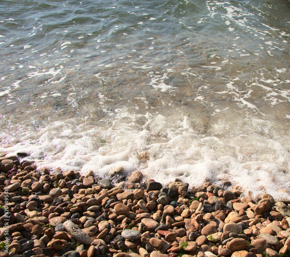 Stone shore of the Black Sea, background. Exciting sea wave. Rest on the shore of the reservoir. Photo without people.