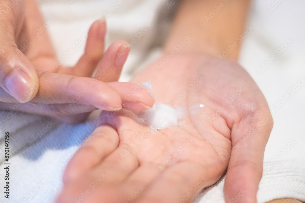 Closeup woman applying moisturizing cream/lotion on hands, beauty concept.. Closeup woman applying moisturizing cream/lotion on hands, beauty concept..
