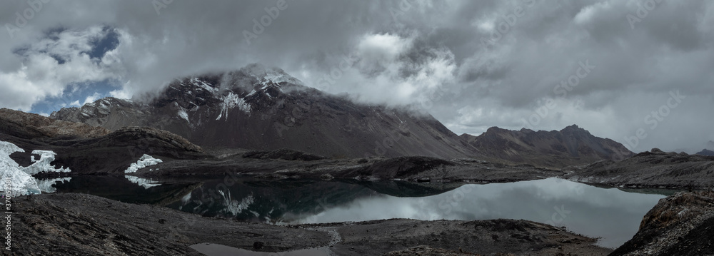 Moody panorama landscape of mountains and lagoon in Nevado Pastoruri, Huaraz, Peru
