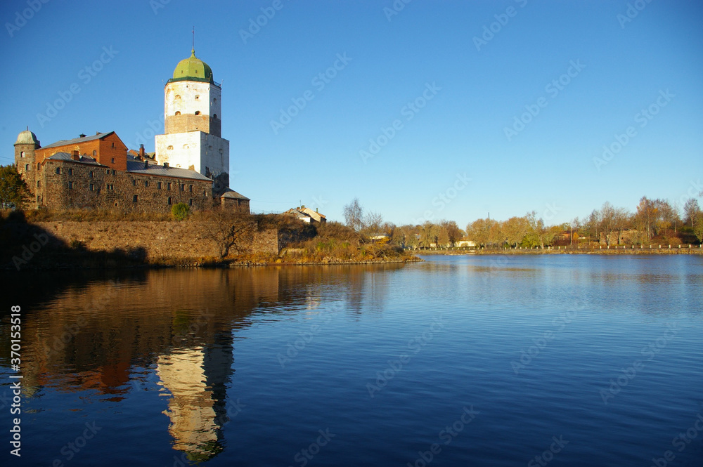 castle on the lake. vyborg castle  reflection in the sea with blue sky and water and in winter .One of the three major castles of Finland. The first record of the castle dates back to 1293.