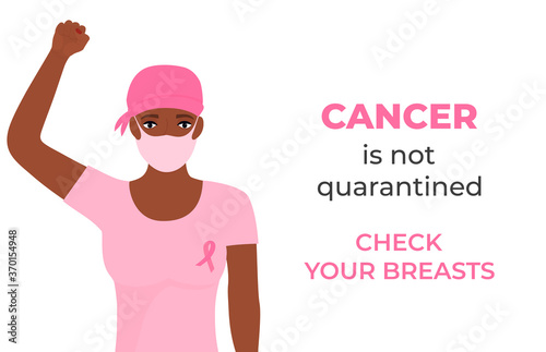 African American women cancer patient wearing headscarf after chemotherapy and medical mask raised her fist during coronavirus quarantine. Check your breasts. October Awareness Month on Women s Health