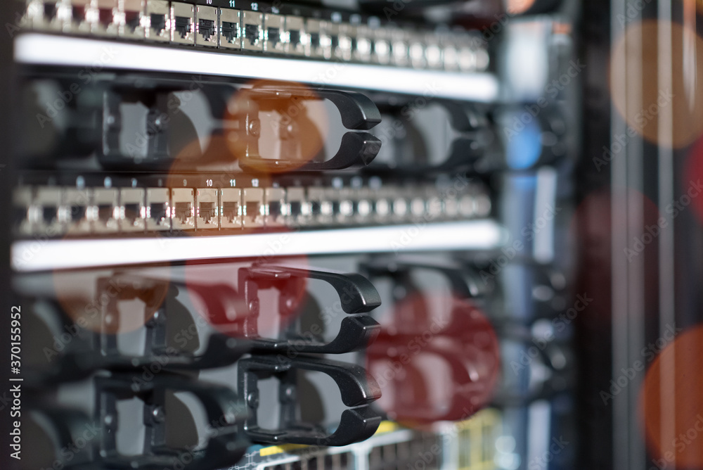 Naklejka premium Hosting platform for modern Internet resources. Rack with server data storage equipment. Many network cables are connected to the data center equipment