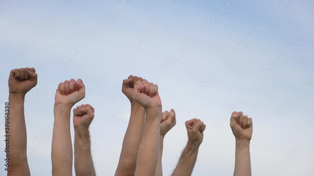 Teamwork. A group of people against the sky raises their hands up. The concept of voluntary voting, expression of consent, support for democracy. Teamwork. A group of people against the sky raises their hands up. The concept of voluntary voting, expression of consent, support for democracy.
