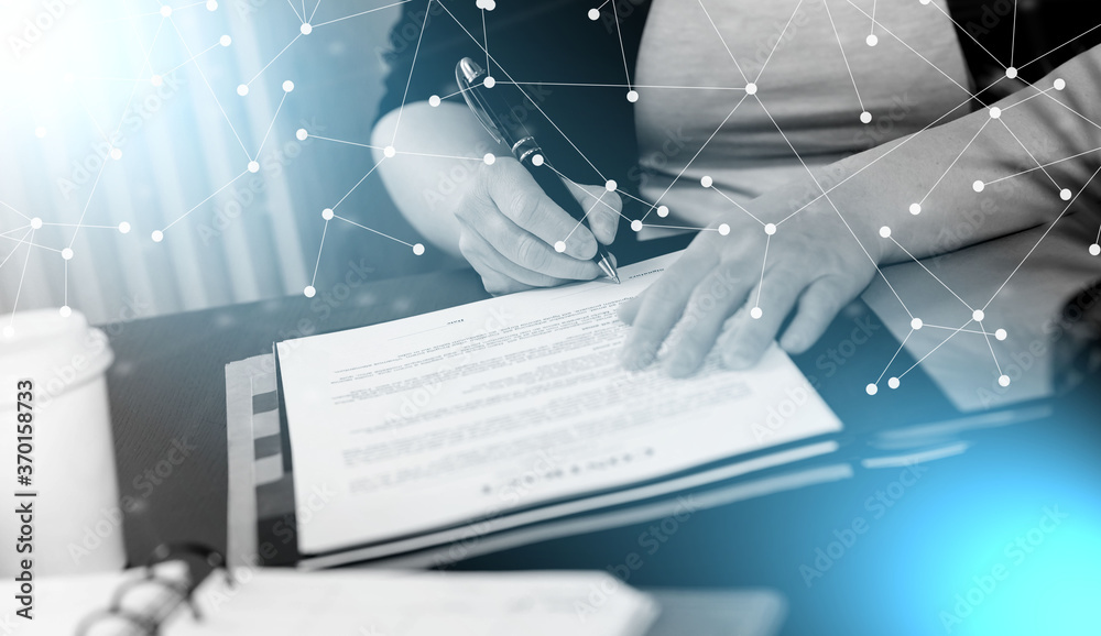 Naklejka premium Businesswoman signing a document; light effect