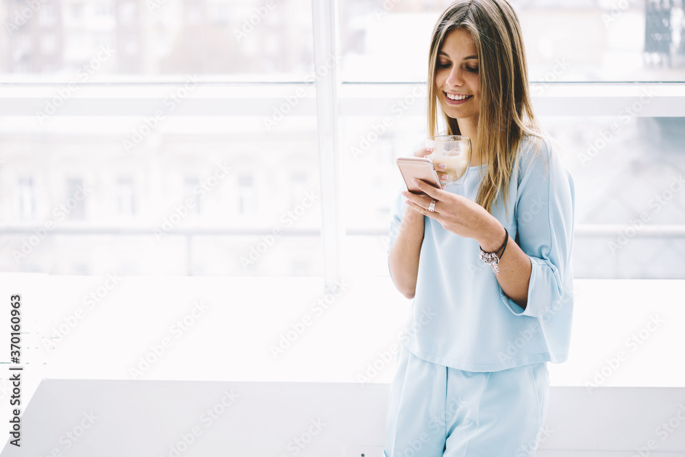Portrait of attractive female executive with natural makeup and in trendy wear checking email box via modern smartphone connected to wireless internet while waiting for feedback from entrepreneur Portrait of attractive female executive with natural makeup and in trendy wear checking email box via modern smartphone connected to wireless internet while waiting for feedback from entrepreneur