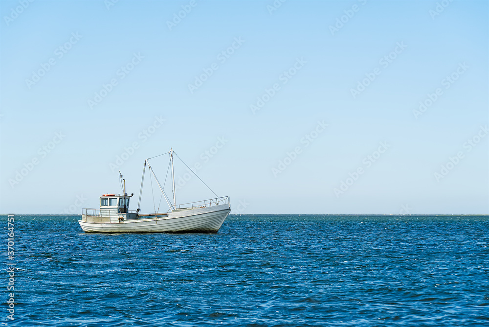 Old Traditional for baltic sea or scandinavian countries Vintage fishing boat in sea. minimalist shot.