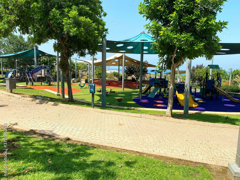 Children playground and sport complex in small park - obrazy, fototapety, plakaty 