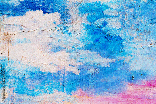 Abstract creative background of chaotic strokes of old cracked paint on concrete wall. Old surface with traces of paint, weathered, scratches and cracks for design