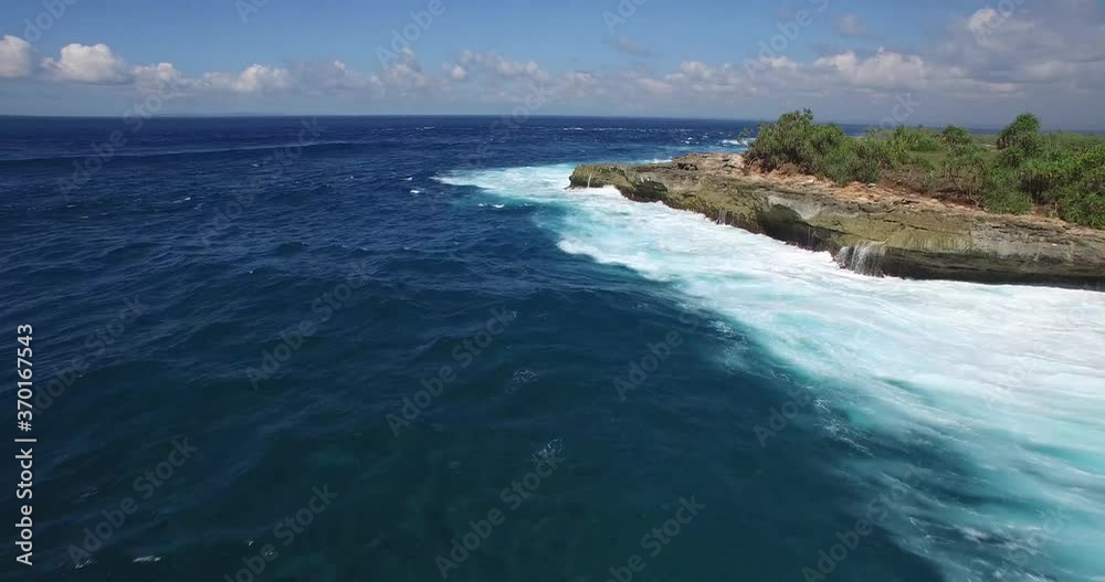 4K AERIAL LOW ANGLE FLY OVER OF DEEP BLUE OCEAN ROCK CLIFFS 4K AERIAL LOW ANGLE FLY OVER OF DEEP BLUE OCEAN ROCK CLIFFS