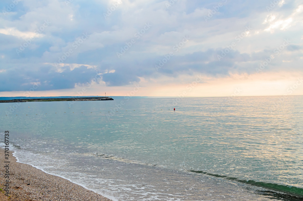 Beach of Black Sea from Golden Sands, Bulgaria with blue clear water, fluffy clouds sky, hotels