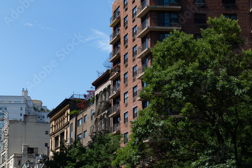 Row of Old Brick Residential Buildings in the East Village of New York City with Balconies and Fire Escapes