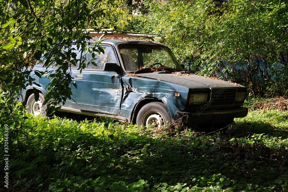 Ramenskoe. Moscow region. Russia. September 23.2015. The old, broken-down LADA car lives out its life in the bushes. Ramenskoe. Moscow region. Russia. September 23.2015. The old, broken-down LADA car lives out its life in the bushes.