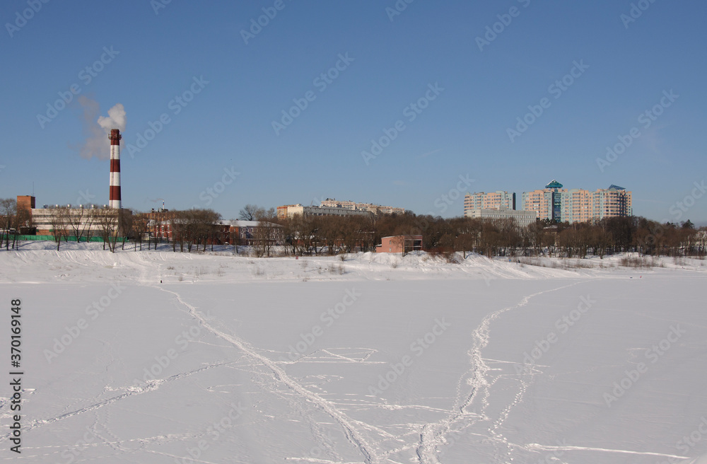 Paths on the ice of Borisoglebsky lake on a Sunny March day. Ramenskoe. Moscow region. Russia.