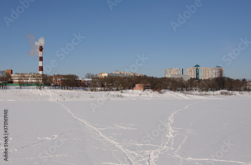 Paths on the ice of Borisoglebsky lake on a Sunny March day. Ramenskoe. Moscow region. Russia. © Andrey
