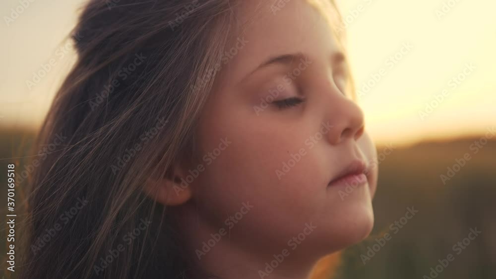 happy little girl child closed her eyes dreams. kid wants a dream come true portrait at sunset. baby daughter silhouette dreaming of a happy childhood. free face sister side view thinks. concept dream happy little girl child closed her eyes dreams. kid wants a dream come true portrait at sunset. baby daughter silhouette dreaming of a happy childhood. free face sister side view thinks. concept dream