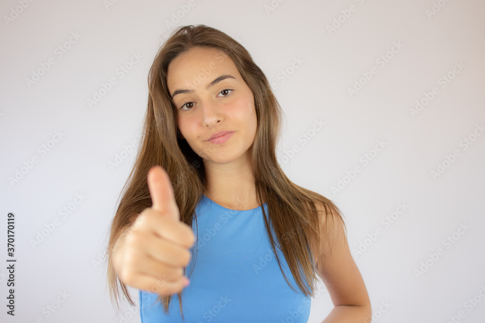 Beautiful young girl making the finger up gesture Beautiful young girl making the finger up gesture