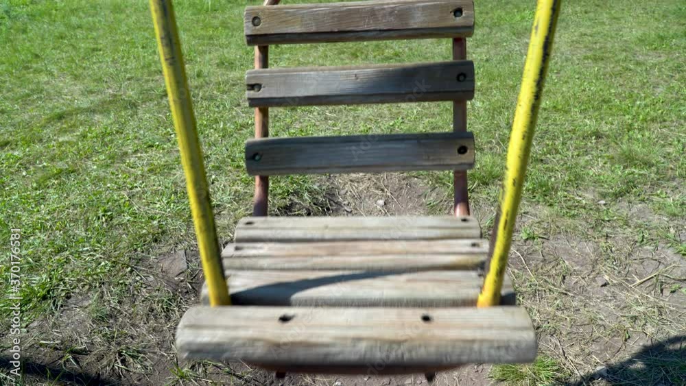 Old metal swing for children. carousel is moving. Empty abandoned city with a playground. empty swing, Old metal swing for children. carousel is moving. Empty abandoned city with a playground. empty swing,