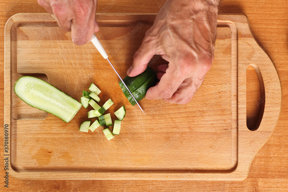 Dicing cucumber. Directly Above.