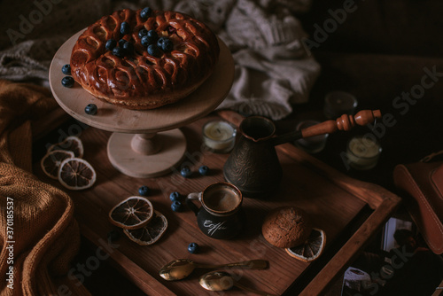 Still life of apple pie, berries, coffee and lemons on wooden tray © Юлия Батаева