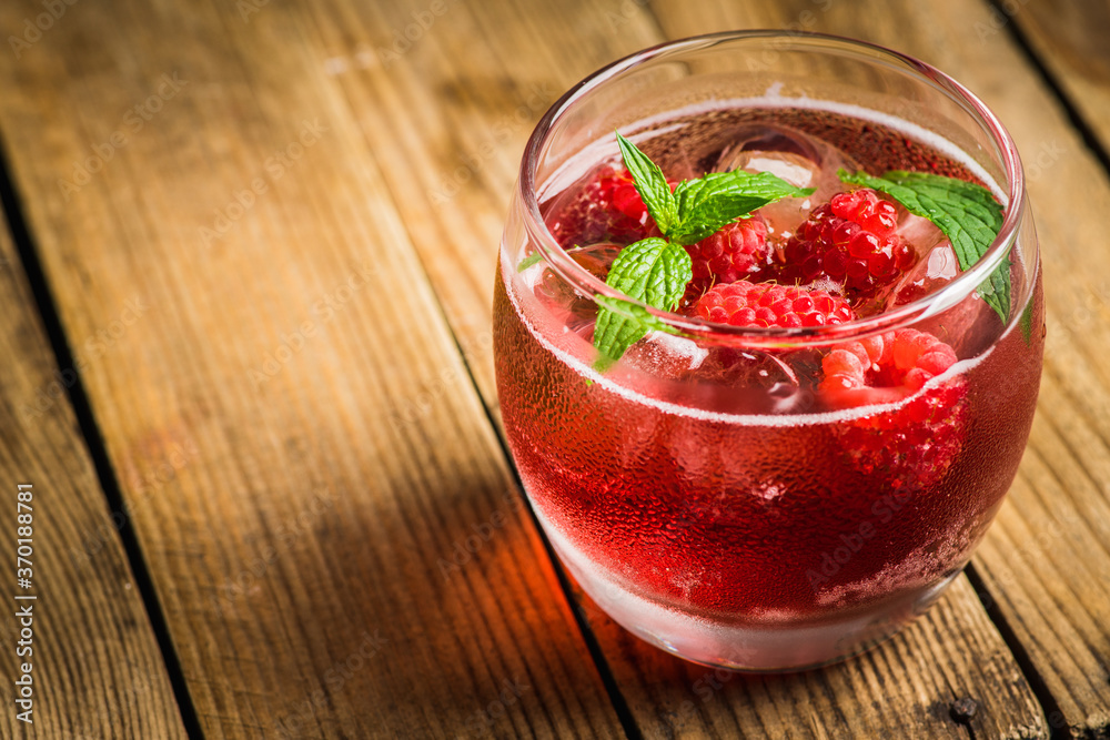 Raspberry and mint cocktail in glass on the rustic background. Selective focus. Shallow depth of field. 