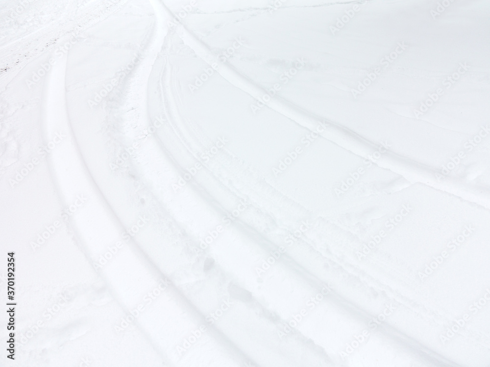 Fototapeta premium Abstract footprints on white snow as a background for any project Christmas