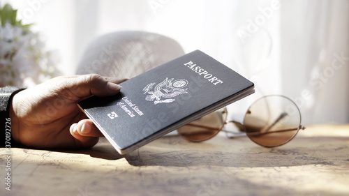 woman holding a passport with a world map travel concept