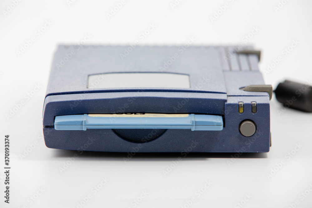zip drive with blue disk inserted over white background zip drive with blue disk inserted over white background