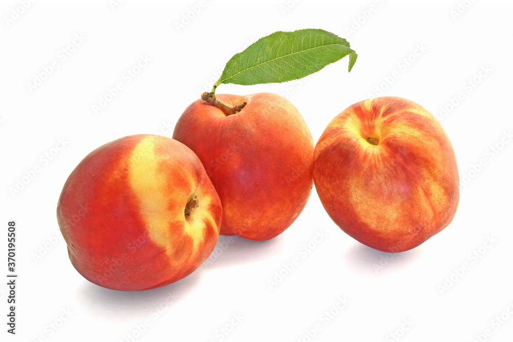 Three peaches with leaf isolated on white