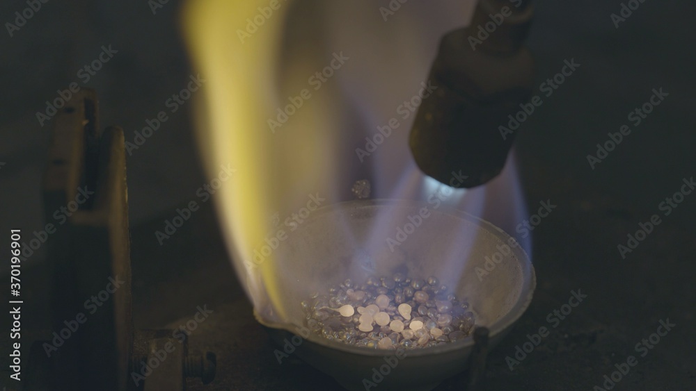 Jeweler melt silver on fire. And poured into special forms. Jeweler melt silver on fire. And poured into special forms.