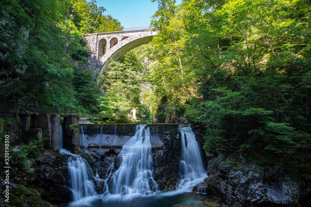 Vintgar Gorge in Slovenia, view of the river and waterfall in the green. Vintgar Gorge in Slovenia, view of the river and waterfall in the green.