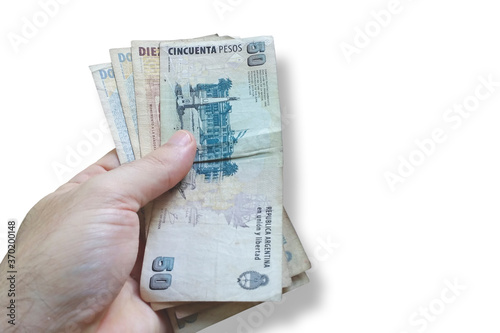 Man's hand holding Argentine money. Banknote Argentine money. Isolated on white background. Finance concept.