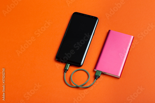 Smartphone charging with power bank. Portable power bank for charging mobile devices.