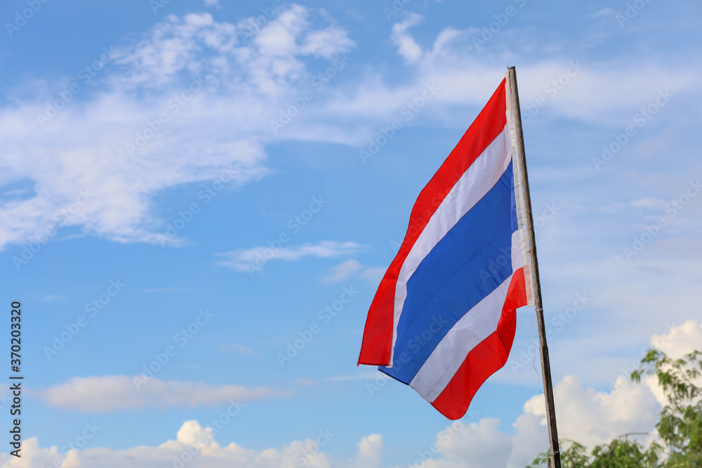 The thailand flag on wood pole have sky background
