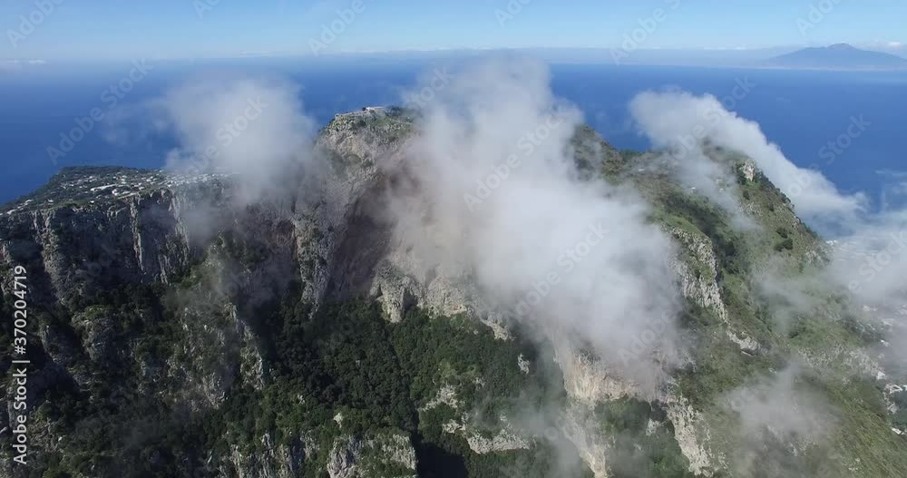 BEAUTIFUL ROLLING CLOUDS OVER STEEP ROCK CLIFFS IN CAPRI ITALY BEAUTIFUL ROLLING CLOUDS OVER STEEP ROCK CLIFFS IN CAPRI ITALY