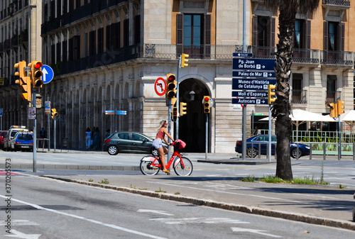 Barcelona, Spain, August 8, 2020: Woman in a bike wearing protective medical masks for prevent virus Covid-19 in Barcelona, Spain, Europe
