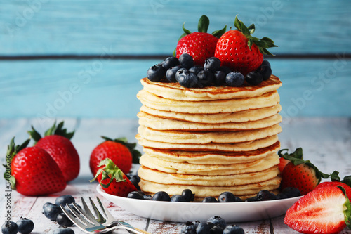 A stack if home-made pancakes with berry