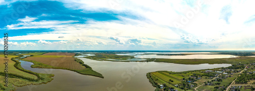 Lebyazhy estuary in the lower reaches of the Beysug river near the village of Chipiginskaya (South Russia, Krasnodar Territory) - aerial panorama from a sunny hot summer day