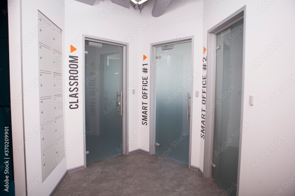 Three doors to workspace rooms at modern office building Three doors to workspace rooms at modern office building