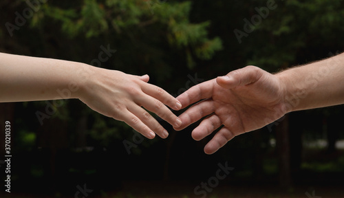  the hand reaches towards the hand. High quality photo