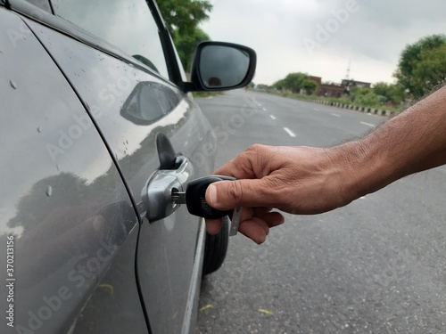 Picture of a person unlocking his car with key