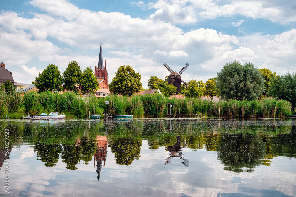 View to shore of Werder, Havel, with Holy Spirit Church -Heilig Geist Kirche- and Bock Windmill -Bockwindmühle- , Potsdam, Germany