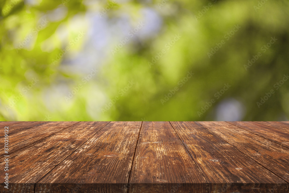 Wooden beautiful table on blurred bokeh background Wooden beautiful table on blurred bokeh background