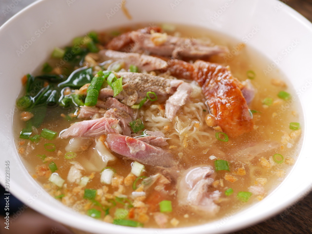 Close up of roasted duck over egg noodles soup ready to be served Close up of roasted duck over egg noodles soup ready to be served