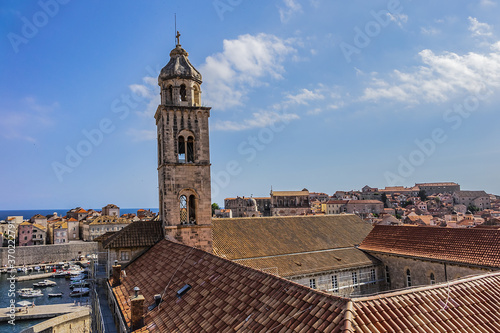 Church tower of Dominican Monastery (Dubrovnik Dominikanski Samostan, 1225) and the orange-tiled roofs of old town. Dubrovnik, Mediterranean, Croatia. photo