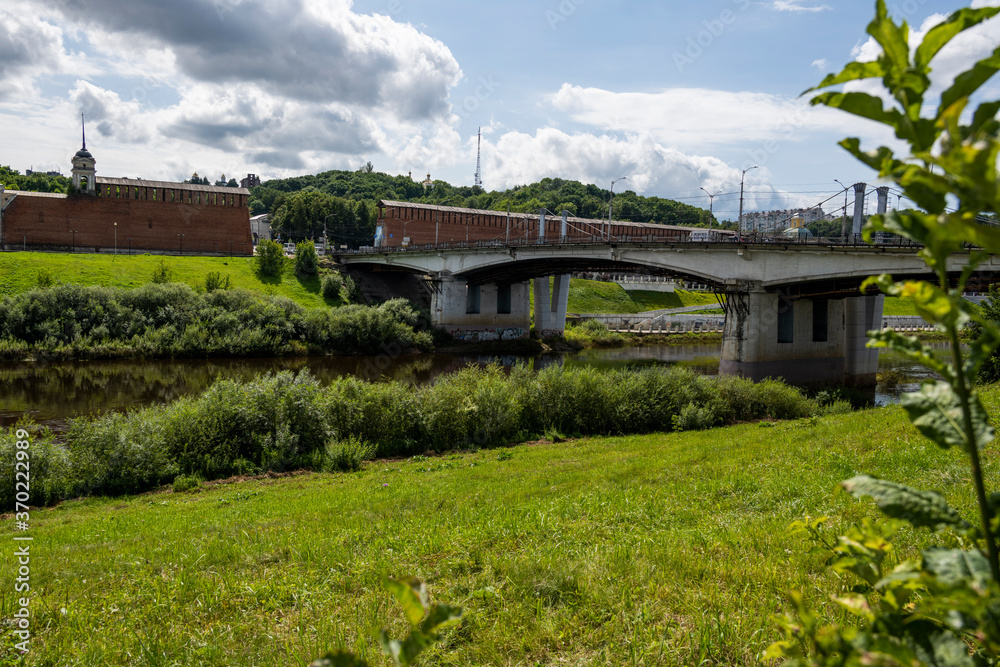 city view with old buildings and green trees and a river