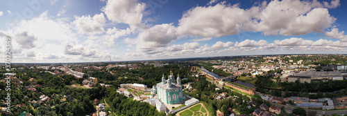 city panoramic landscape in summer with a temple on a hill filmed from a drone